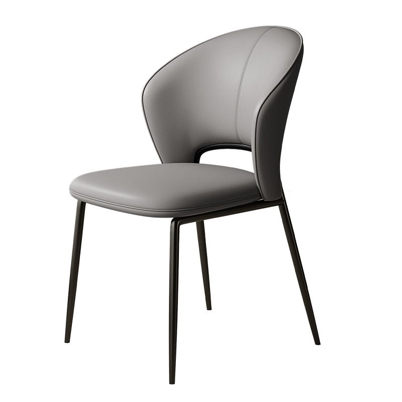 A sleek chair featuring a beige curved backrest and seat, complemented by slender black metal legs