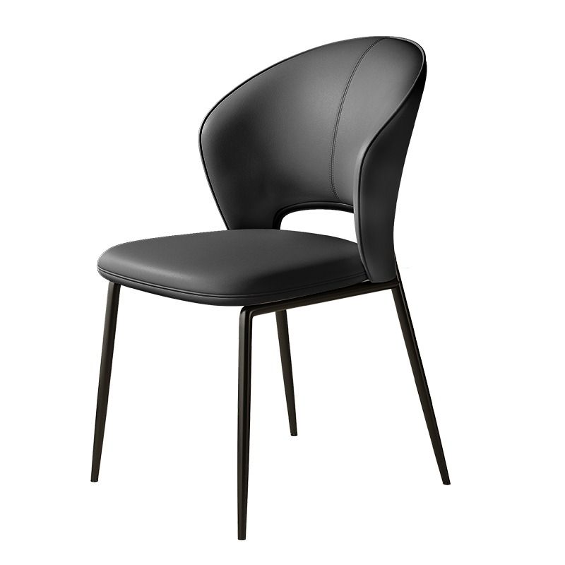 A sleek chair featuring a beige curved backrest and seat, complemented by slender black metal legs