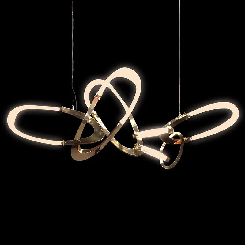 Gold contemporary hanging light above dining table