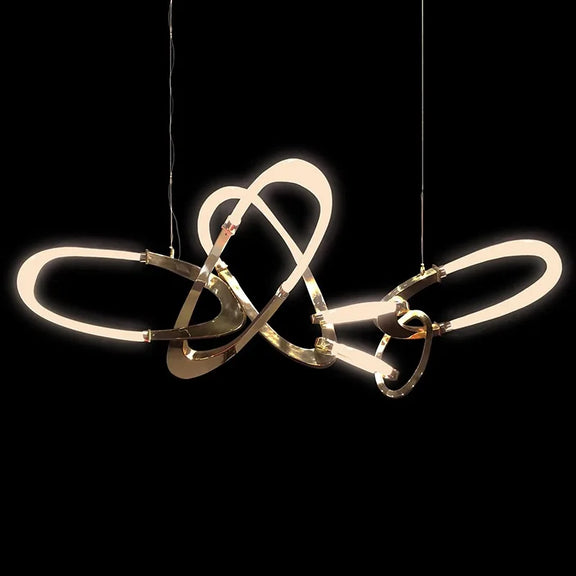 Gold contemporary hanging light above dining table