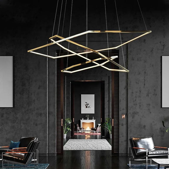 Gold geometric multi-ring LED chandelier suspended from ceiling
