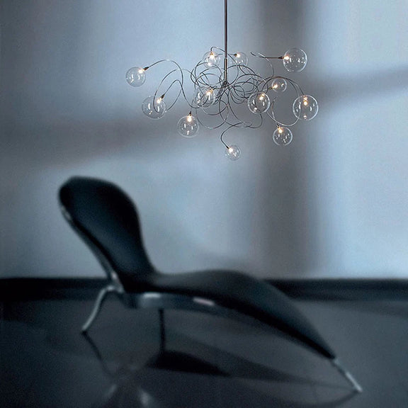 Smoke glass branching chandelier over dining table