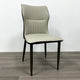 A striking chair with a terracotta leather seat, vertical stitching, and contrasting black legs