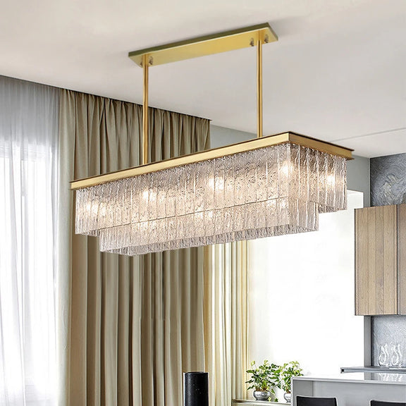 Gold linear chandelier with layered glass design over dining table