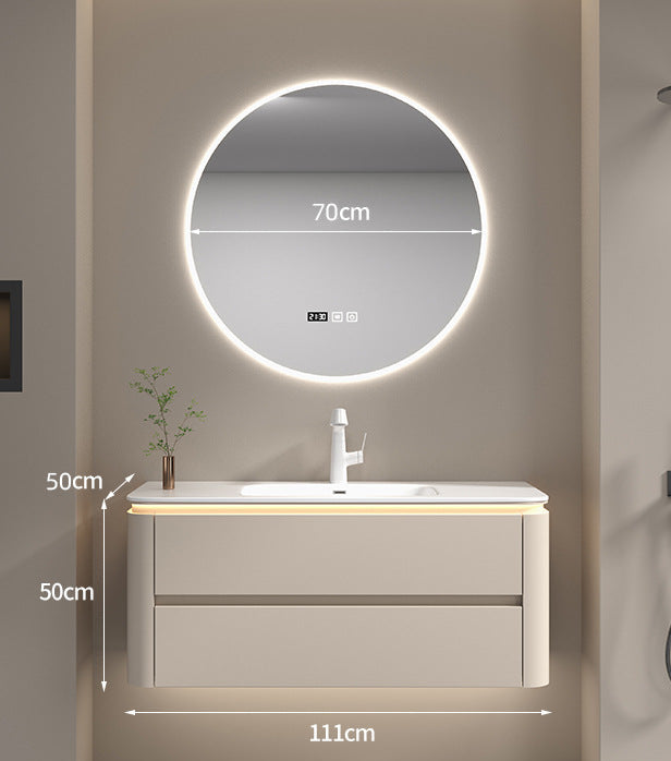 Cream bathroom vanity with seamless countertop and faucet