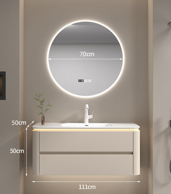 Cream bathroom vanity with seamless countertop and faucet