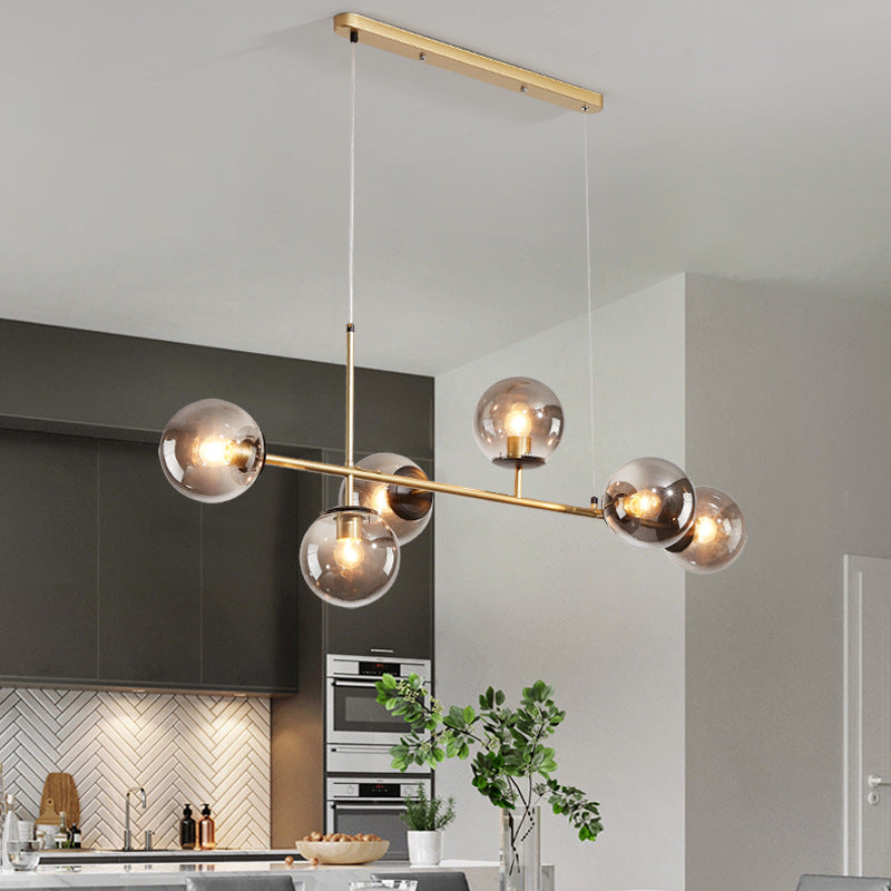 Contemporary glass globe pendant light above dining table