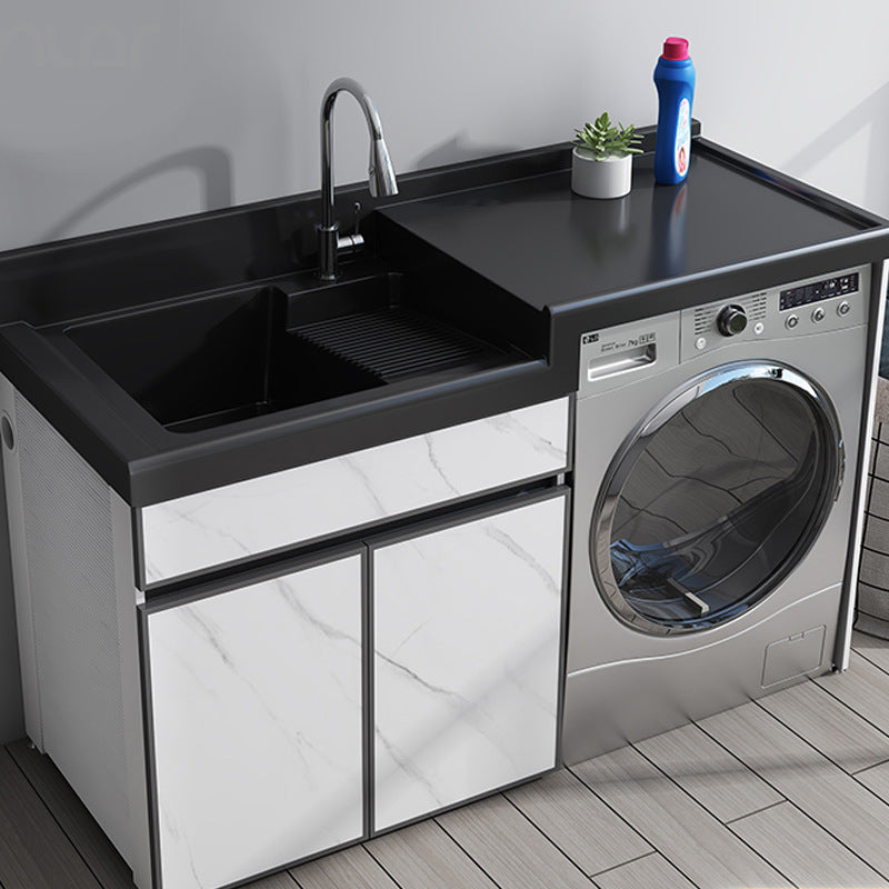 marble finish laundry cabinet with integrated black quartz basin