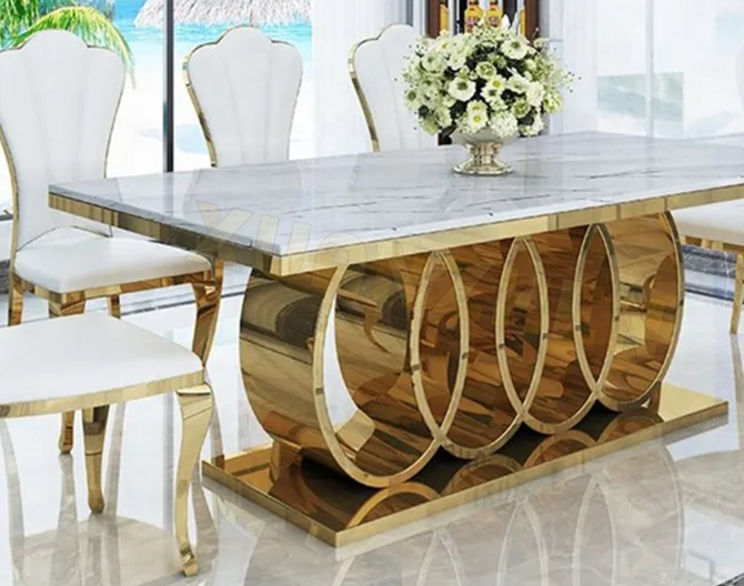 light luxury dining table set featuring a rectangular design. This  sleek marble tabletop with durable stainless steel legs, complemented by matching chairs for a refined and modern dining experience